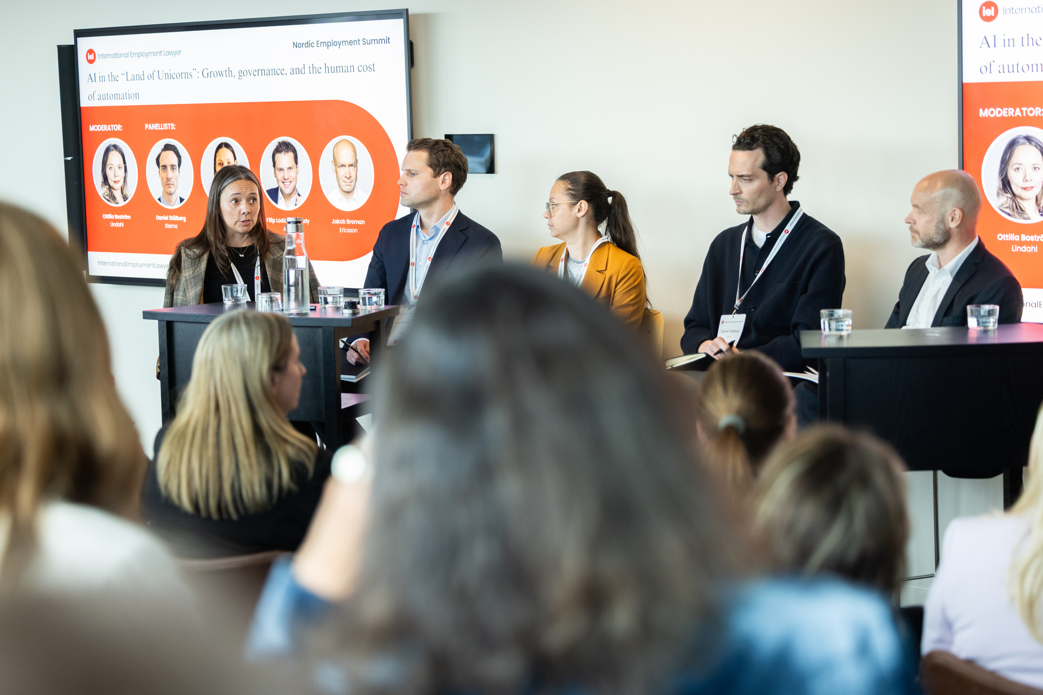 Panel speaking in front of crowd