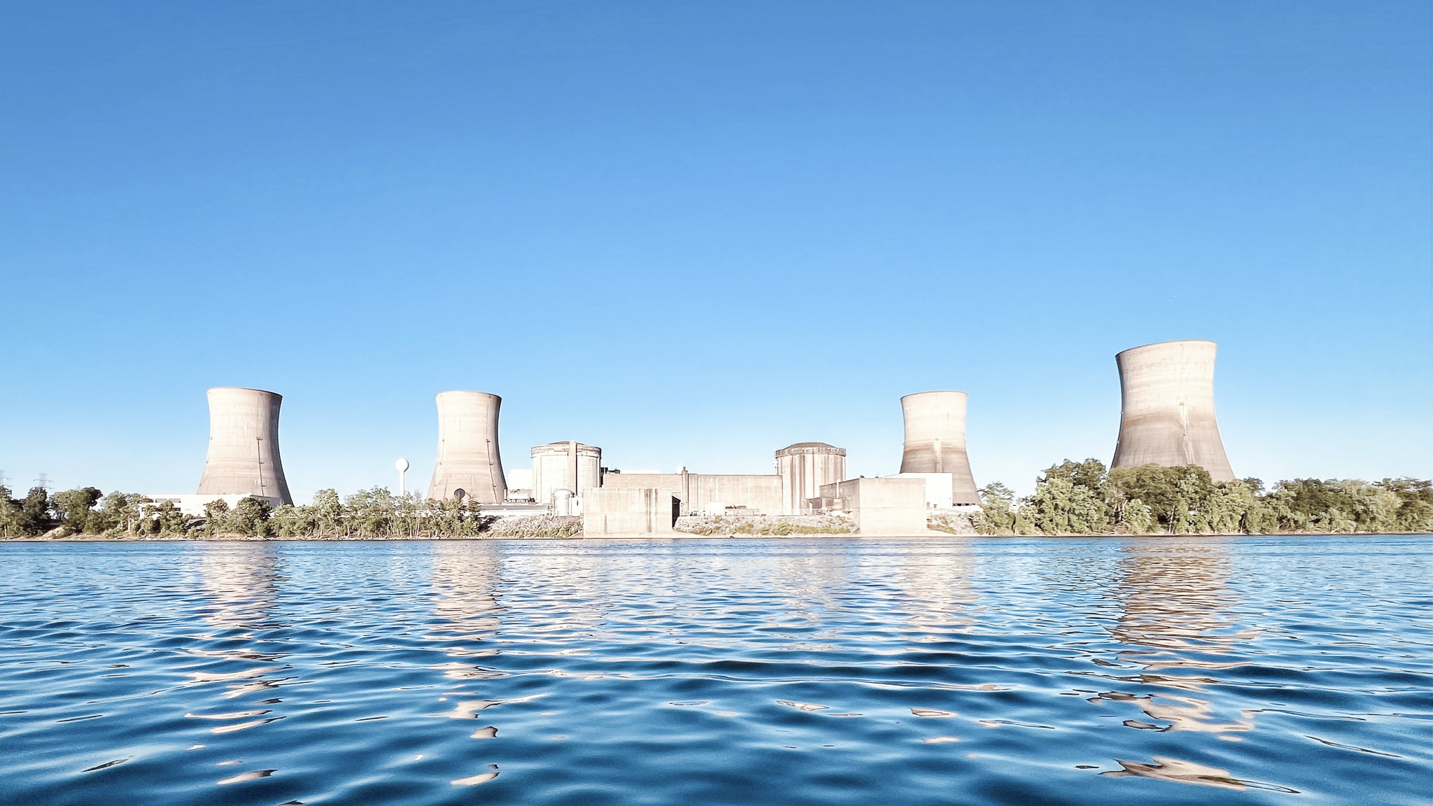 Power station by the water and blue sky