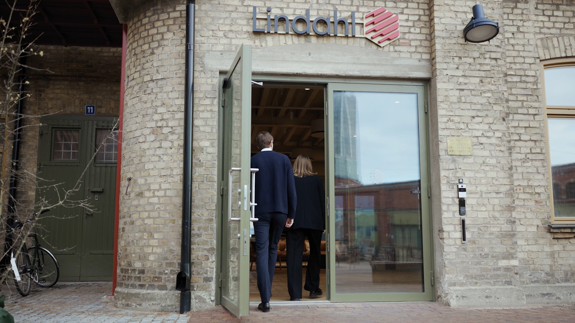 Man and woman walking inside a Lindahl office entrence